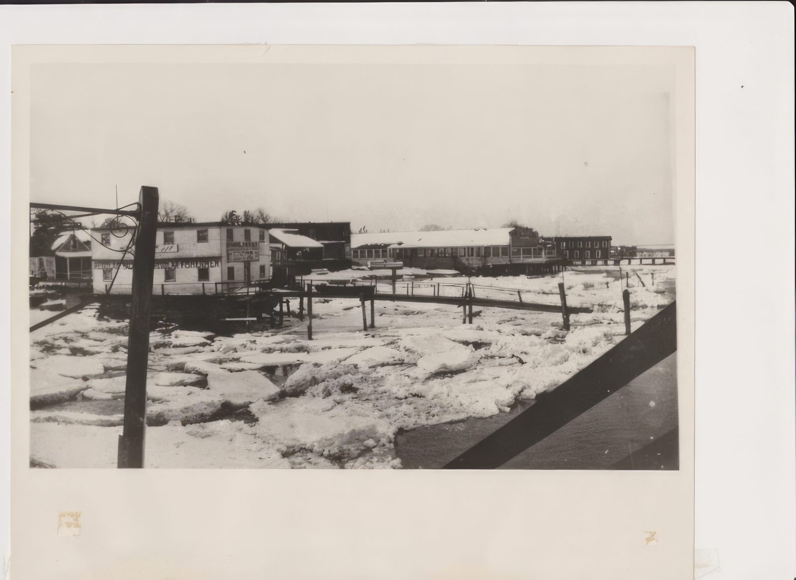 Black-and-white photograph of Bahrs Landing during its first winter in 1917, ice running through the marina